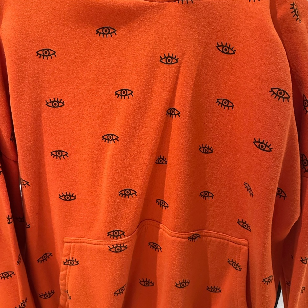 Adika Orange Sweater with Eye Design